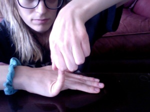 Image: Me, Beth, stretching my pinky finger of my right hand back at a ninety-degree angle.
