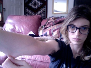 Image: Me, Beth, a 26-year-old thin, pale, white woman, stretching the skin out on my lower right arm.